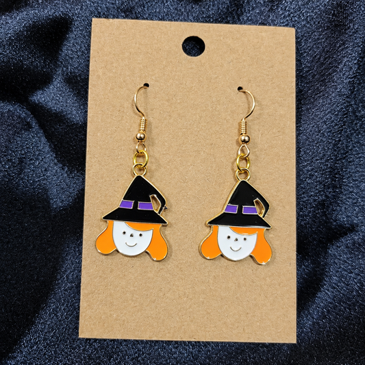 Smiling witch girl enamel drop earrings on kraft card
