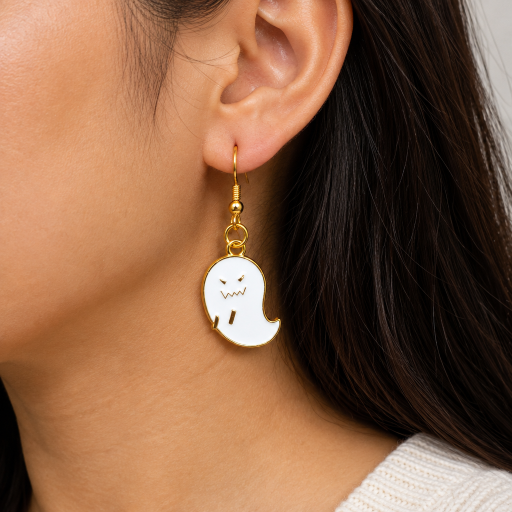 Woman wearing grumpy ghost enamel drop earrings