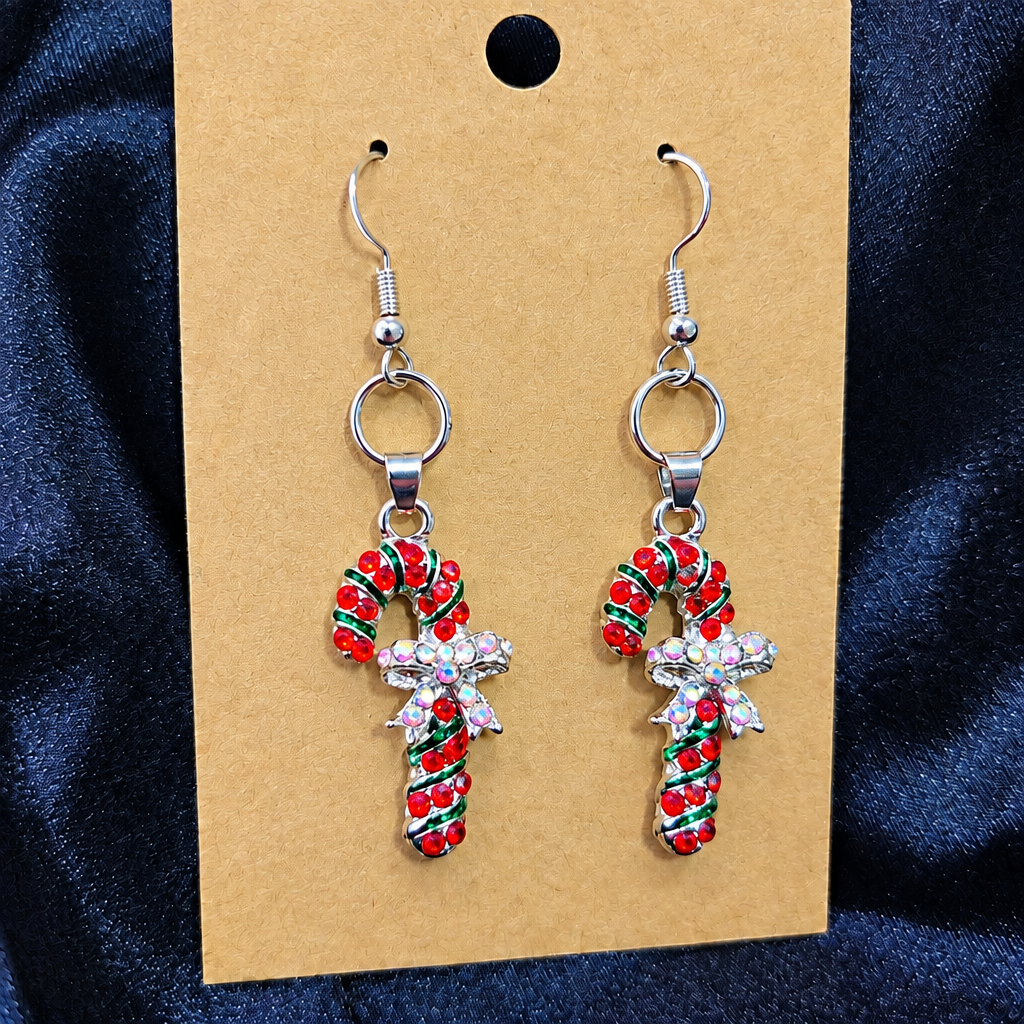 Woman wearing rhinestone candy cane drop earrings