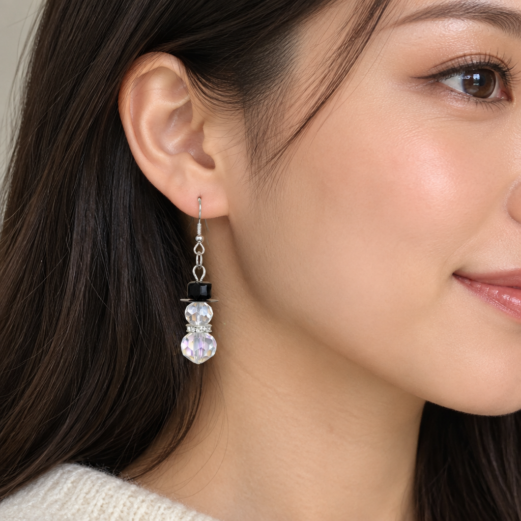 Woman wearing crystal snowman beaded drop earrings