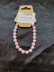 Pink and silver pearlescent bead stretch bracelet on display card