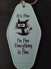 It's Fine I'm Fine Everything Is Fine mint green motel-style keychain with frazzled black cat