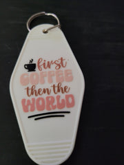First Coffee Then The World white motel-style keychain with steaming coffee cup icon and rose pink lettering