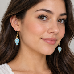 Woman wearing mummy enamel drop earrings