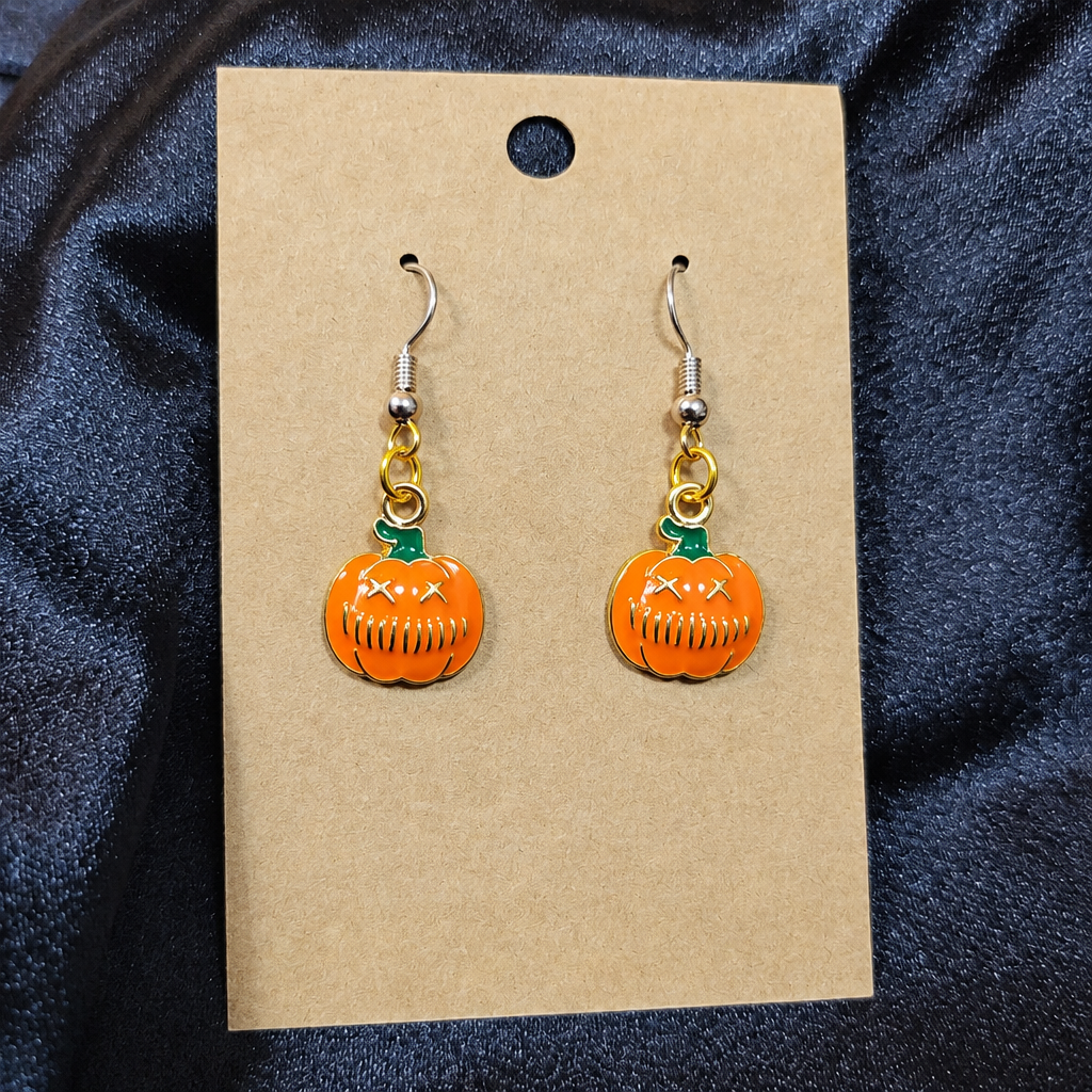 Grumpy pumpkin enamel drop earrings on kraft card
