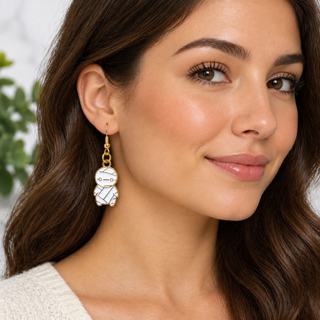 Woman wearing chibi mummy enamel drop earrings