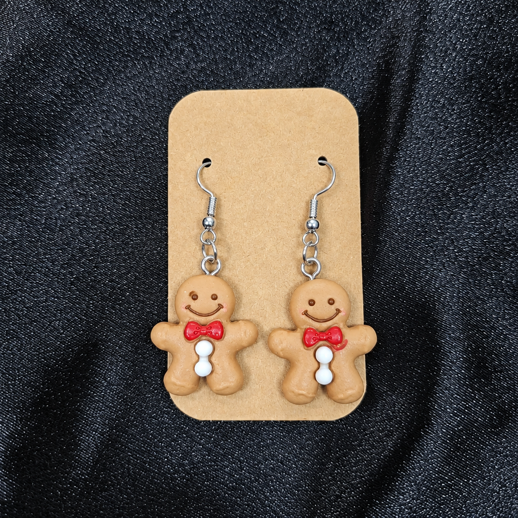 Woman wearing gingerbread man drop earrings