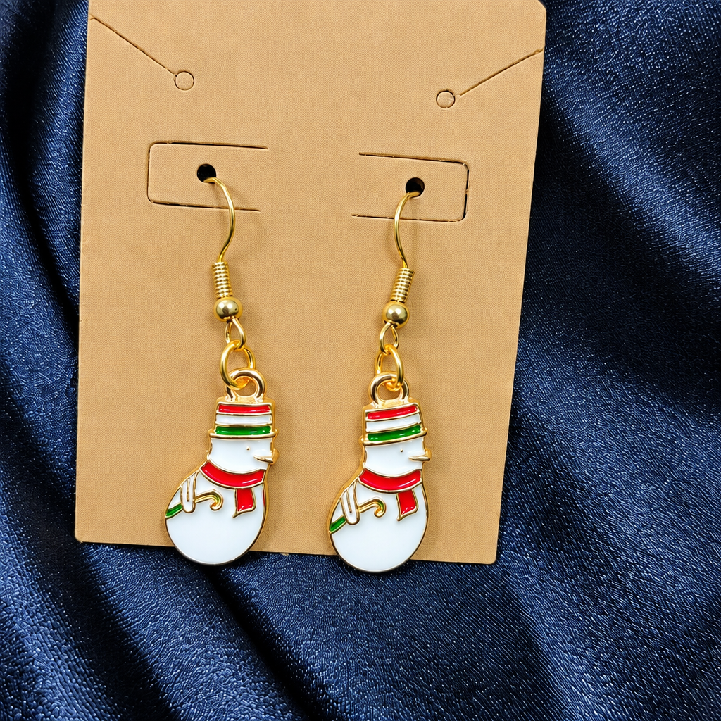 Woman wearing enamel snowman drop earrings