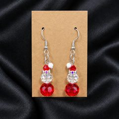 Woman wearing red crystal snowman beaded drop earrings