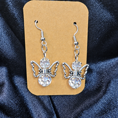 Woman wearing crystal angel beaded drop earrings