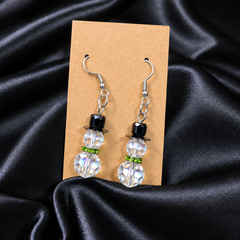 Woman wearing AB crystal snowman beaded drop earrings