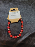 Red and bronze pearlescent bead stretch bracelet on display card