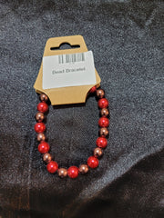 Red and bronze pearlescent bead stretch bracelet on display card