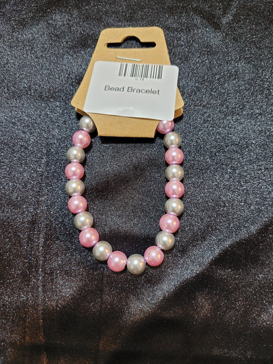 Pink and silver pearlescent bead stretch bracelet on display card