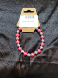Hot pink and silver metallic bead stretch bracelet on display card