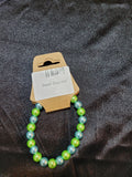 Green and blue pearlescent bead stretch bracelet on display card