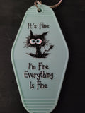 It's Fine I'm Fine Everything Is Fine mint green motel-style keychain with frazzled black cat