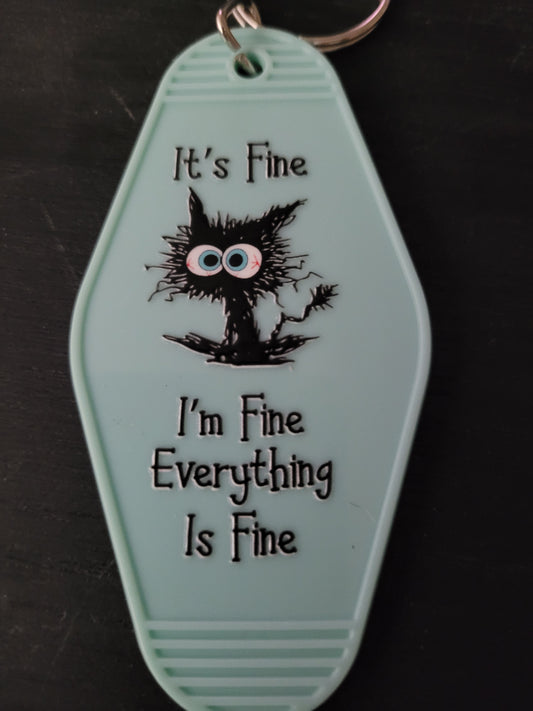 It's Fine I'm Fine Everything Is Fine mint green motel-style keychain with frazzled black cat