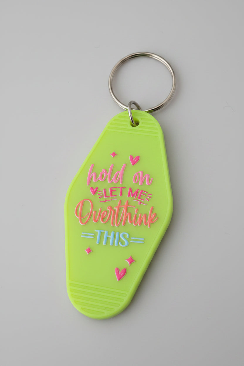 Hold On Let Me Overthink This neon green motel-style keychain with pink and blue lettering