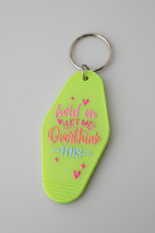 Hold On Let Me Overthink This neon green motel-style keychain with pink and blue lettering