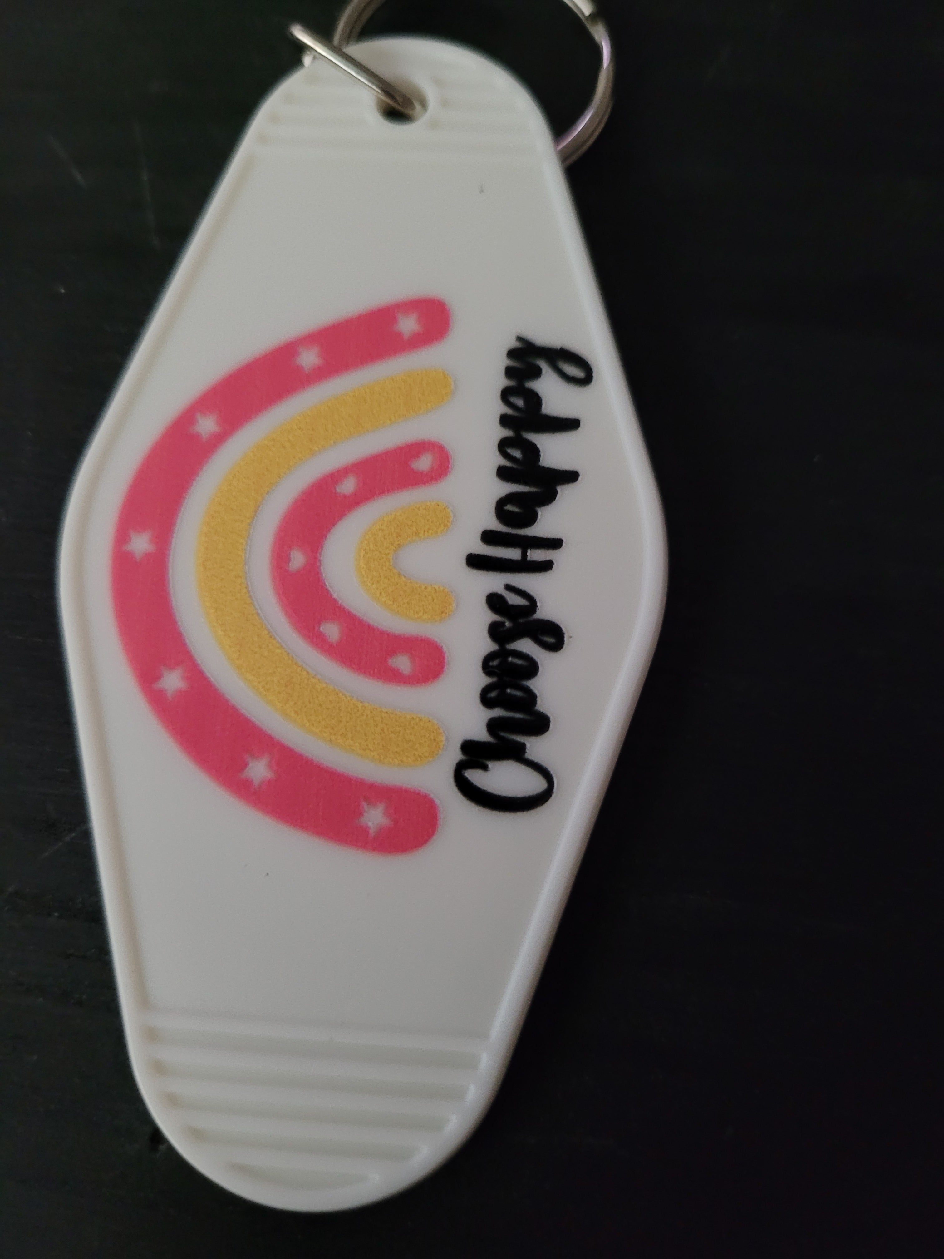Choose Happy white motel-style keychain with pink and yellow rainbow