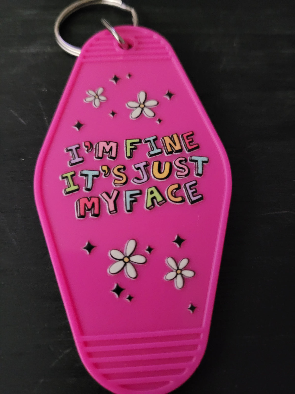 I'm Fine It's Just My Face hot pink motel-style keychain with rainbow lettering and daisy accents