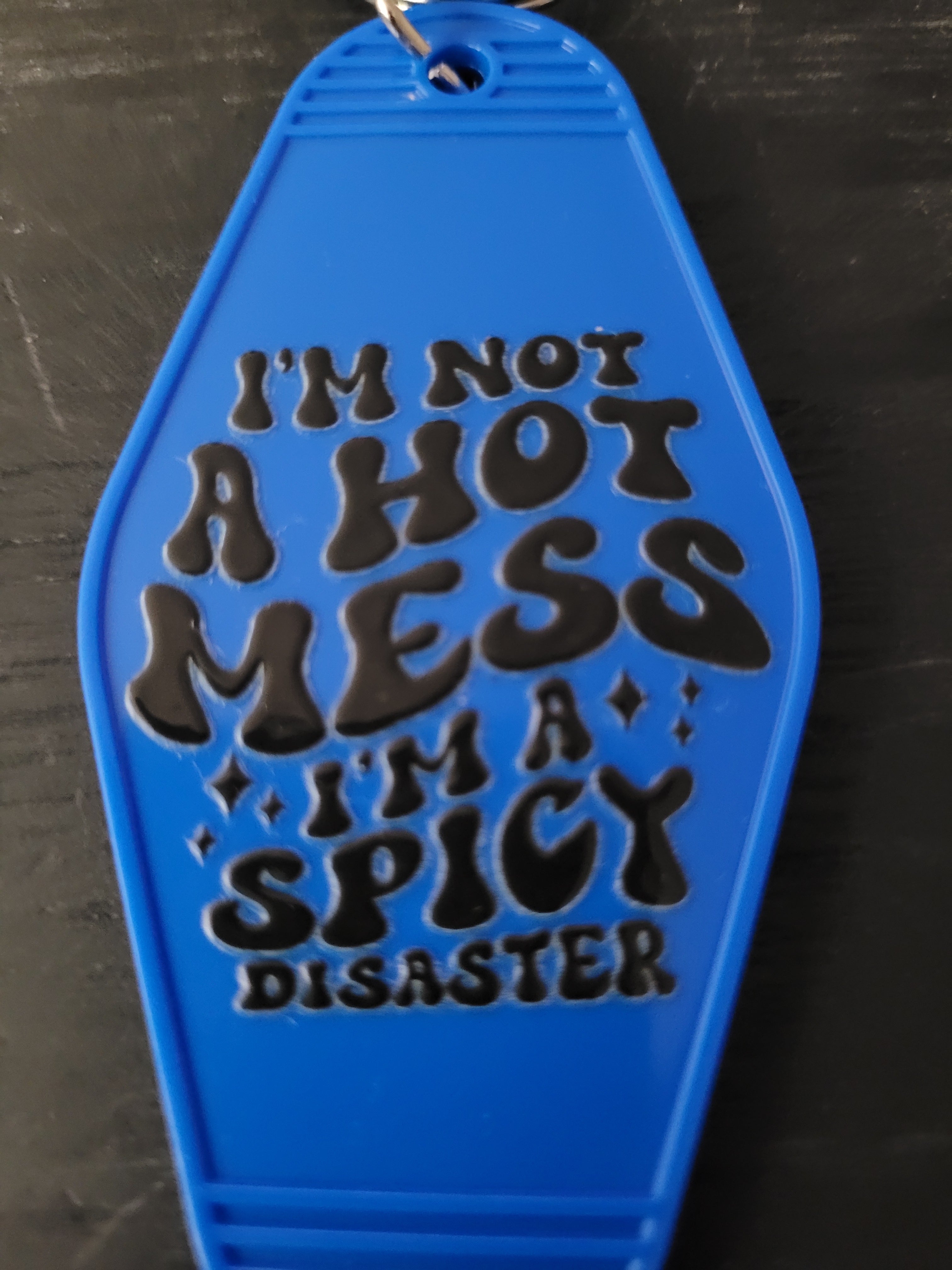 I'm Not A Hot Mess I'm A Spicy Disaster bold blue motel-style keychain with black retro lettering
