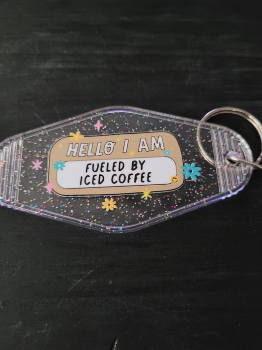 Hello I Am Fueled By Iced Coffee black glitter motel-style keychain with colorful daisies and sparkle stars