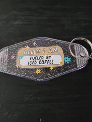 Hello I Am Fueled By Iced Coffee black glitter motel-style keychain with colorful daisies and sparkle stars