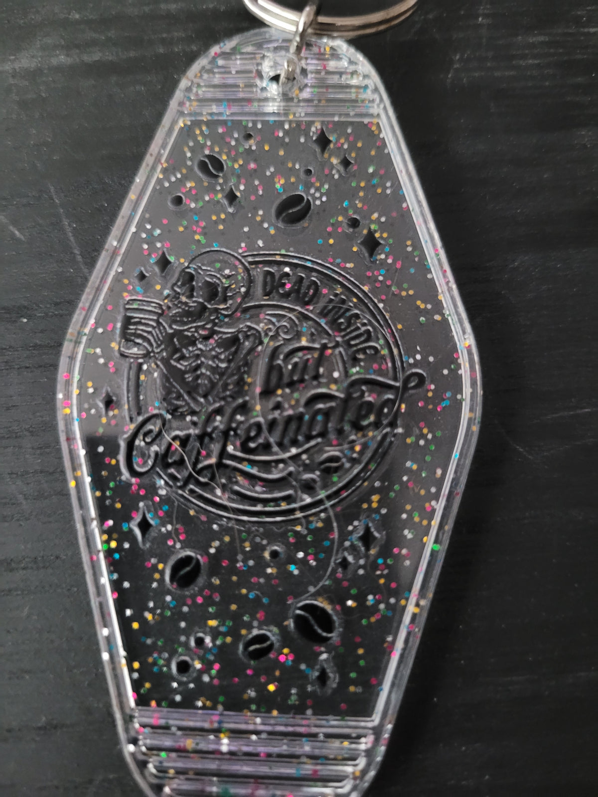 Dead Inside But Caffeinated clear rainbow glitter motel-style keychain with skeleton and coffee bean cutouts