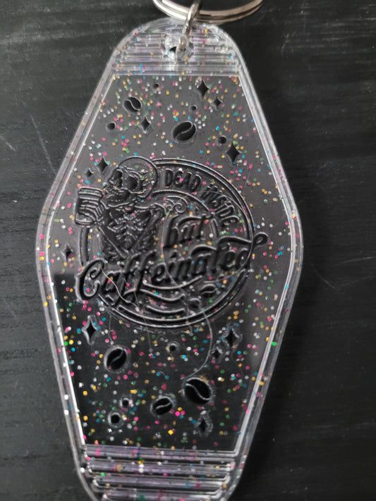 Dead Inside But Caffeinated clear rainbow glitter motel-style keychain with skeleton and coffee bean cutouts