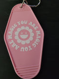 You Are Magic pink motel-style keychain with smiley daisy flower and circular lettering