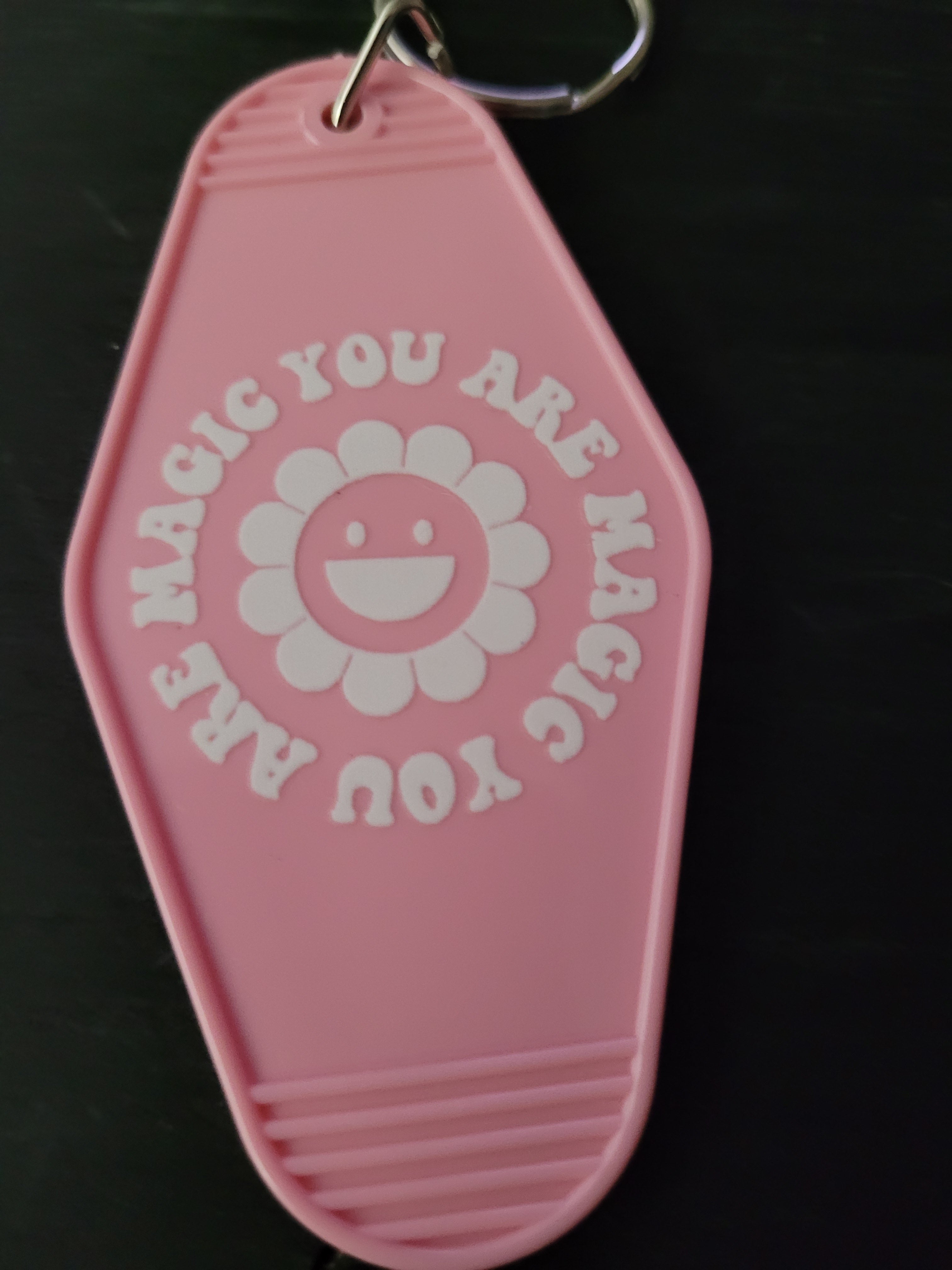 You Are Magic pink motel-style keychain with smiley daisy flower and circular lettering