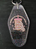 Running On Caffeine and Chaos black rainbow glitter motel-style keychain with skeleton hand holding iced coffee