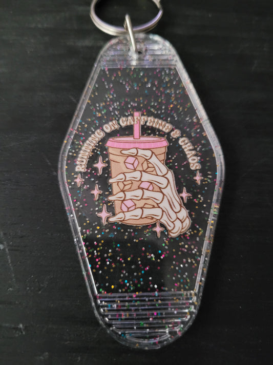 Running On Caffeine and Chaos black rainbow glitter motel-style keychain with skeleton hand holding iced coffee