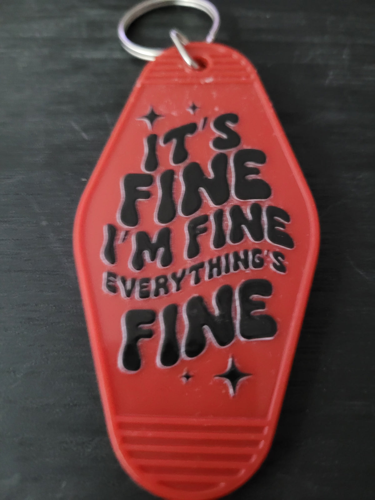 It's Fine I'm Fine Everything's Fine bold red motel-style keychain with groovy black lettering and sparkle accents