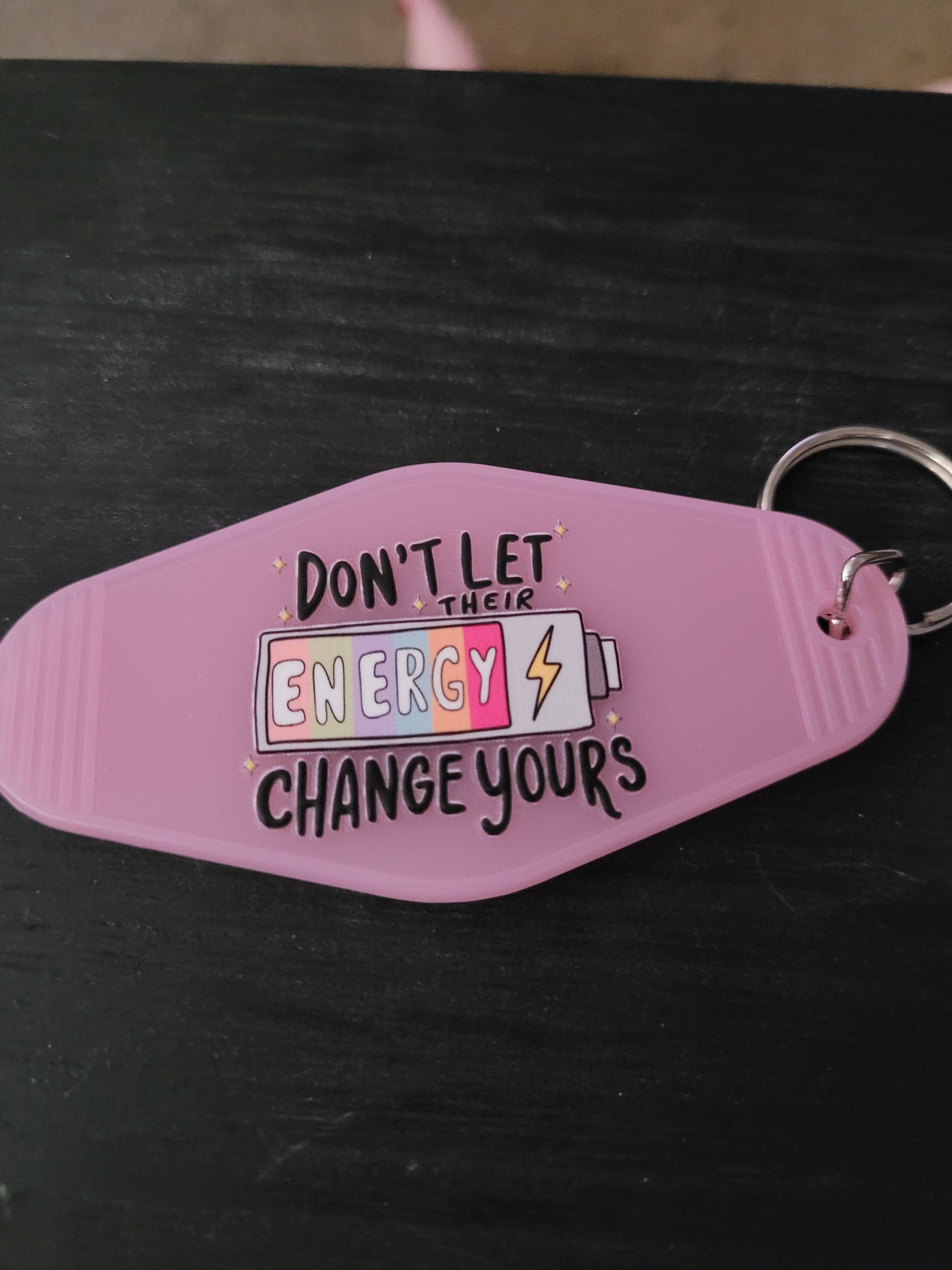 Don't Let Their Energy Change Yours lavender motel-style keychain with colorful battery and lightning bolt
