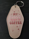 My Blood Type Is Coffee cream motel-style keychain with pink retro lettering and sparkle star cutouts