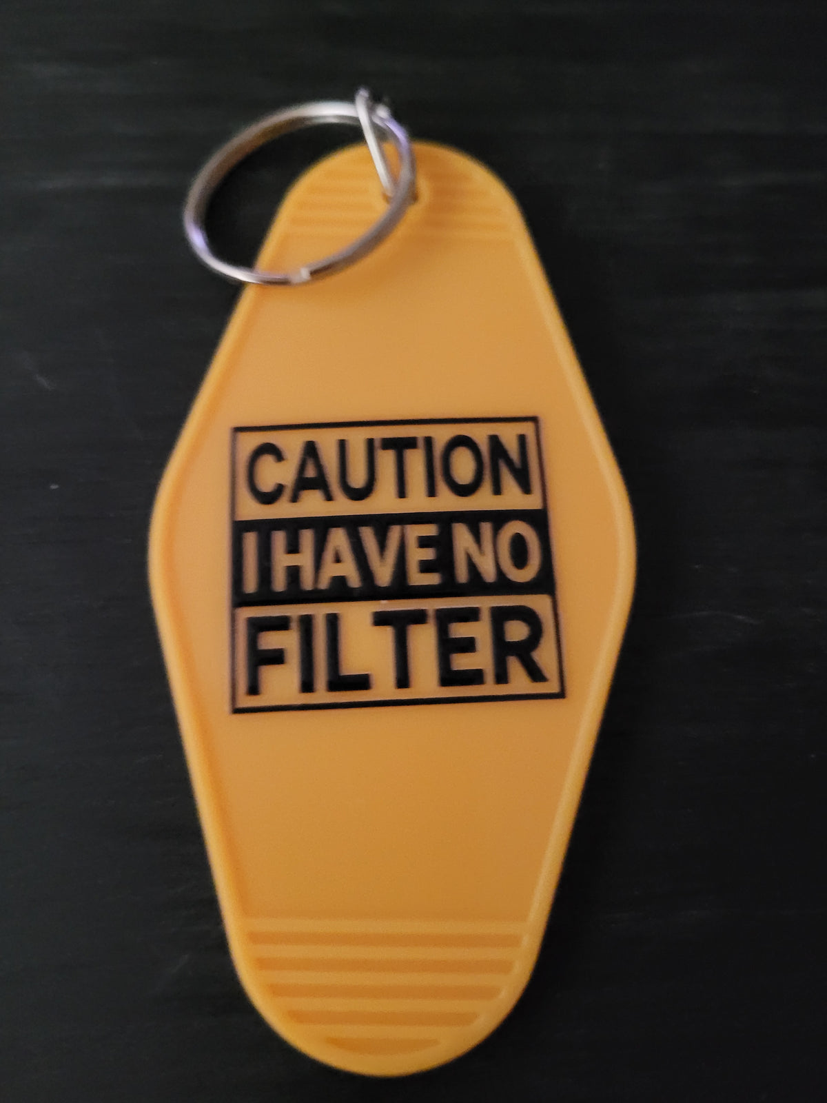 Caution I Have No Filter bold yellow motel-style keychain with black warning label block lettering