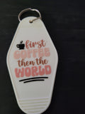 First Coffee Then The World white motel-style keychain with steaming coffee cup icon and rose pink lettering