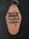 Hold On Let Me Overthink This warm peach motel-style keychain with bold block lettering and sparkle star cutouts