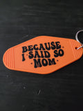 Because I Said So Mom bold orange motel-style keychain with chunky black groovy lettering and sparkle star accents