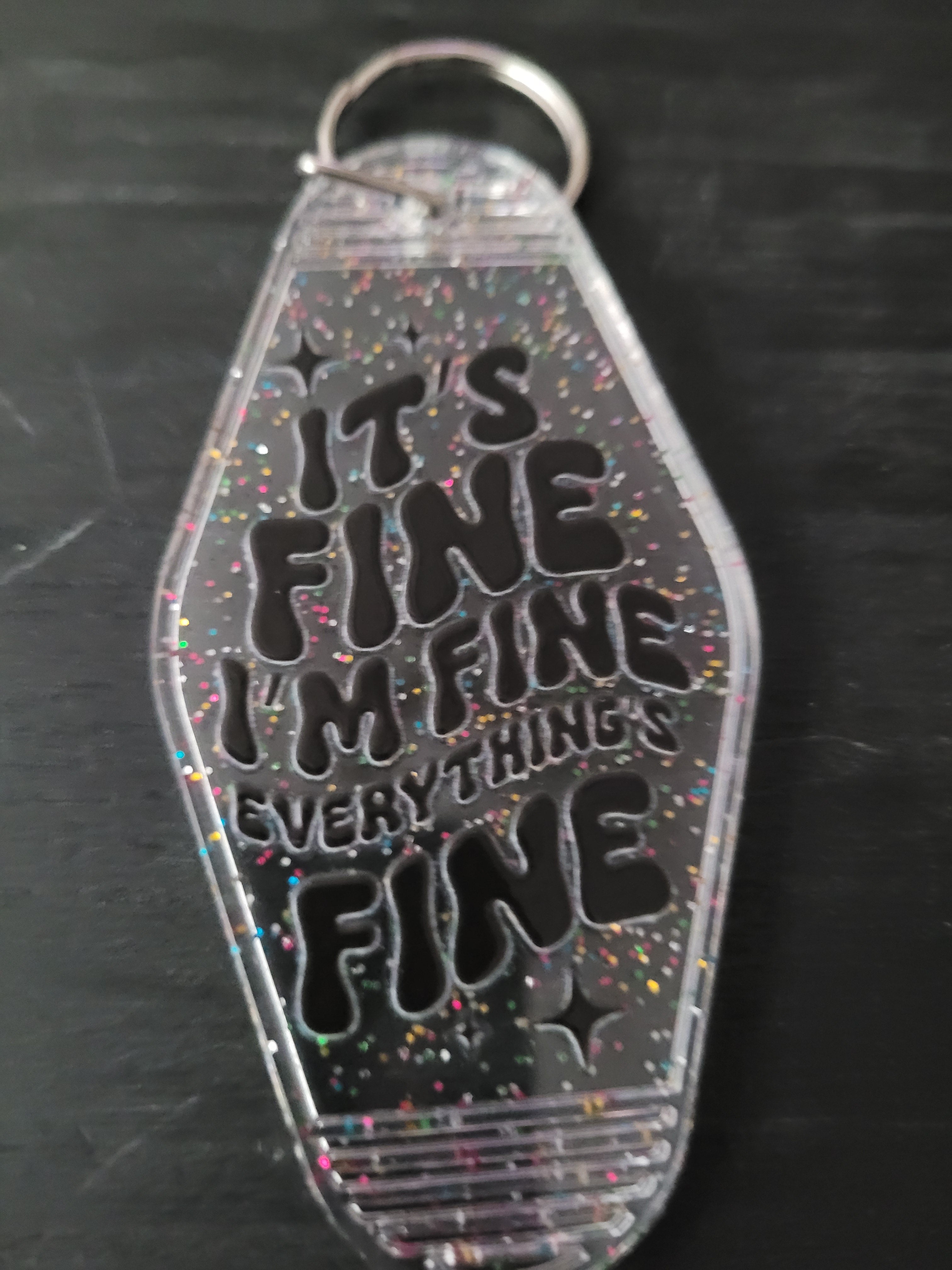 It's Fine I'm Fine Everything's Fine clear rainbow glitter motel-style keychain with bold black chunky groovy lettering