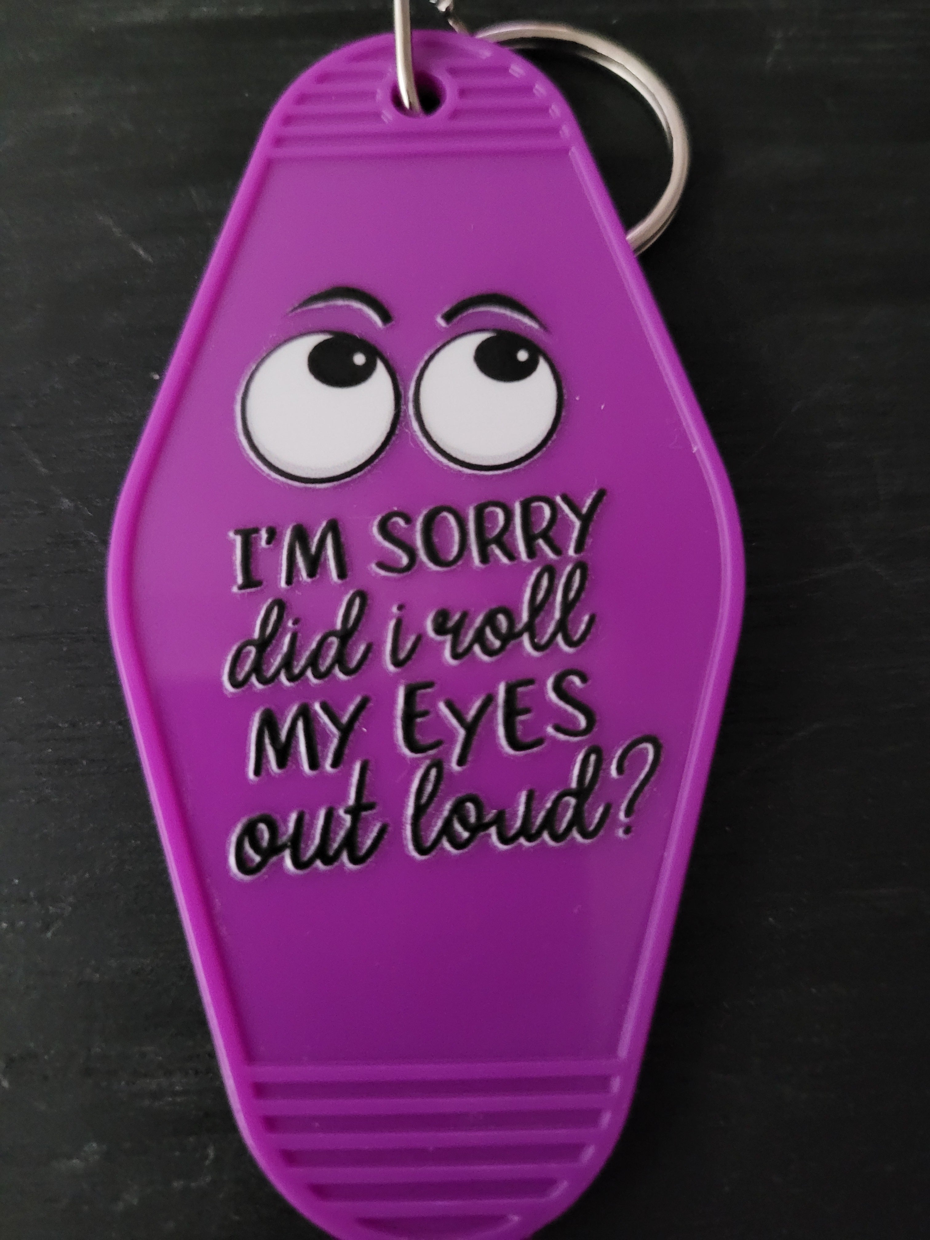 I'm Sorry Did I Roll My Eyes Out Loud bold purple motel-style keychain with cartoon sideways-glancing eyes and mixed block and script lettering