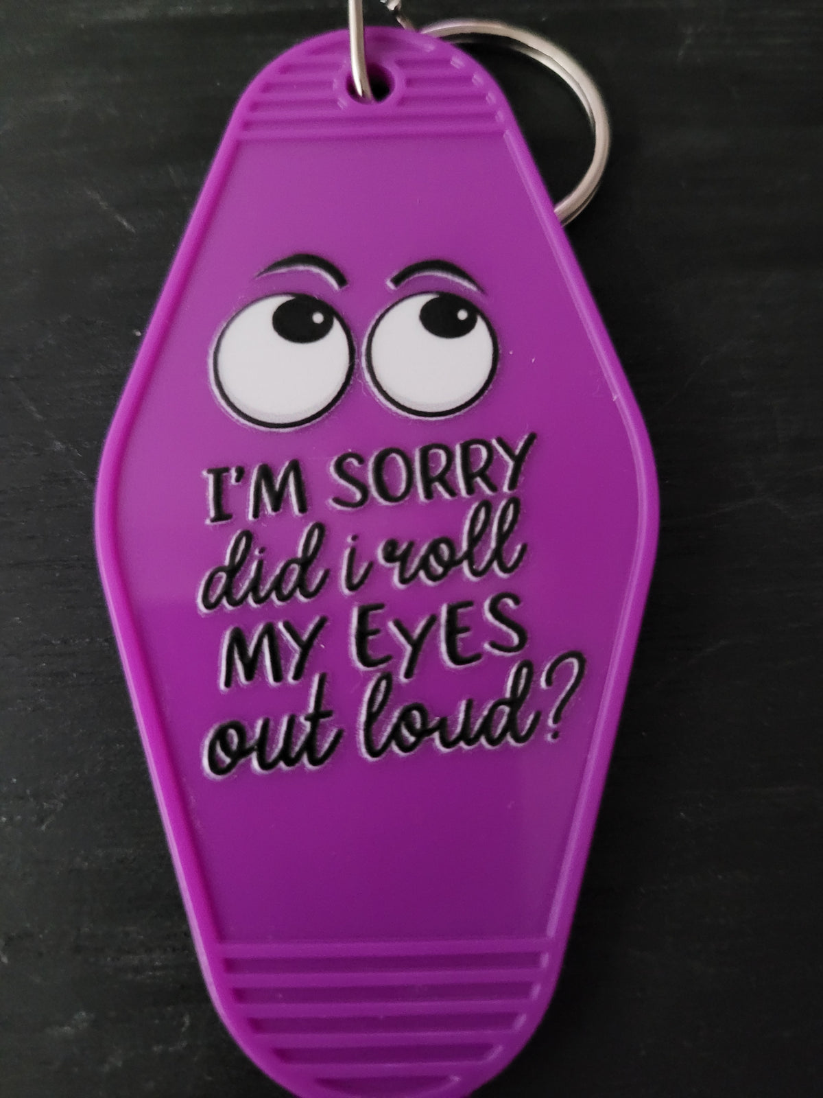 I'm Sorry Did I Roll My Eyes Out Loud bold purple motel-style keychain with cartoon sideways-glancing eyes and mixed block and script lettering