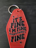 It's Fine I'm Fine Everything's Fine bold red motel-style keychain with chunky black groovy bubble lettering and sparkle star cutouts